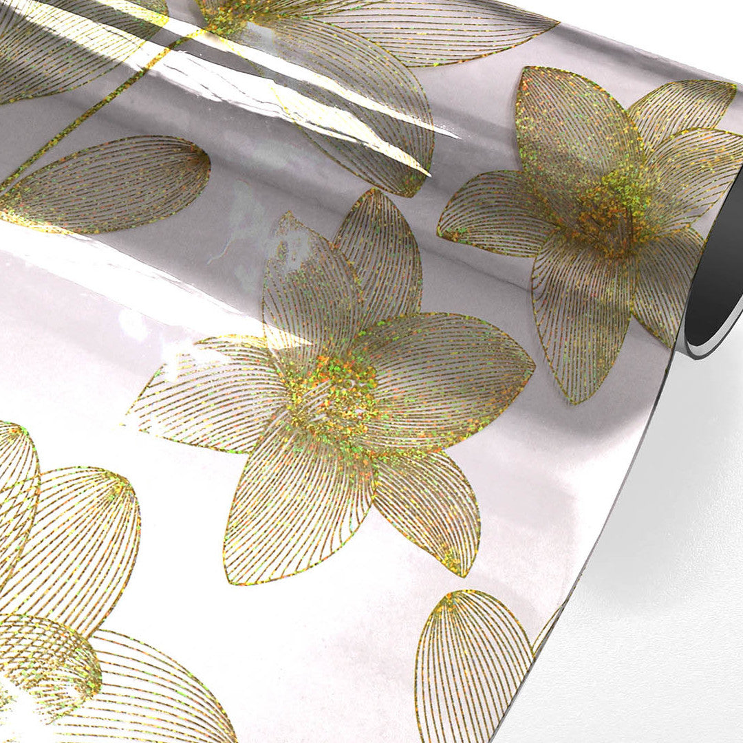 Danela Gold – Gjennomsiktig voksduk, strekblomster og glittereffekt, rullet