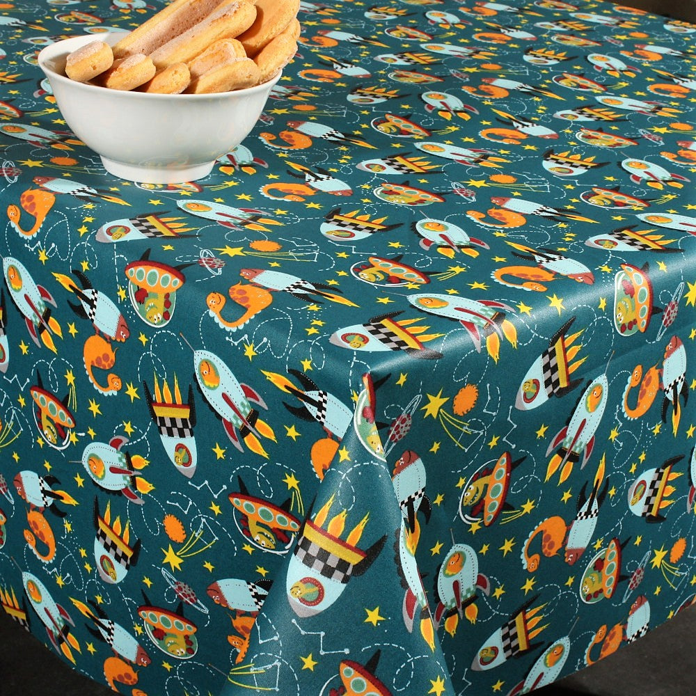 Dinofuzzy blågrønn - Akrylduk med romskip 155 cm bred