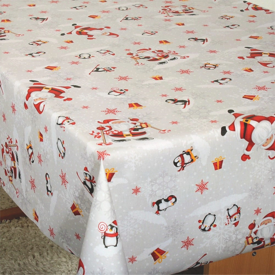 Julefest på Sydpolen juleduk på bord, med morsomme julenisser og pingviner