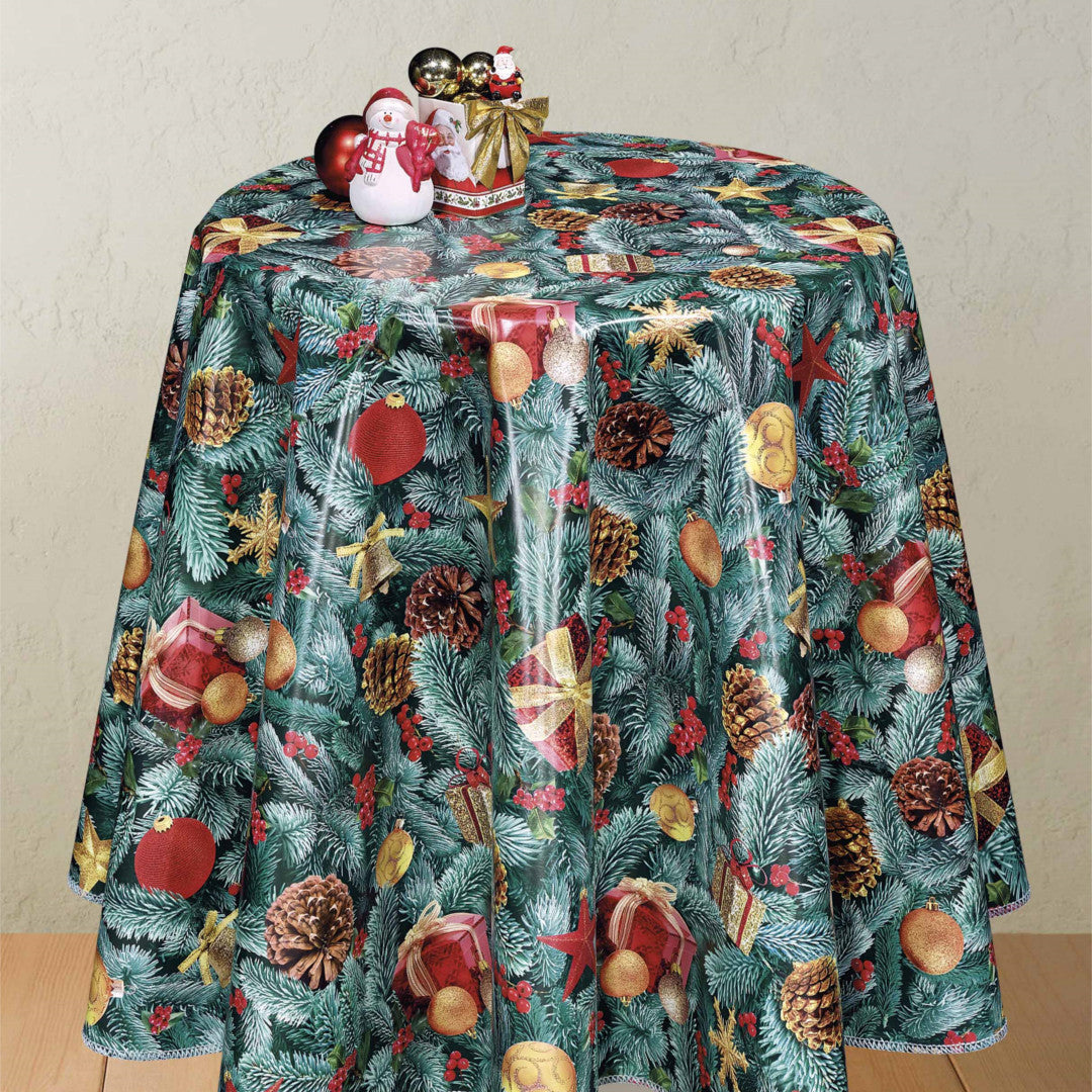 Rund julevoksduk med pyntet gran og juletrepynt