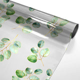 Eucalys – Klar plastduk med gyllent bladprint rullet