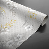 Hortense – Voksduk med blomstrete mønster i gyldne og nøytrale toner, rullet