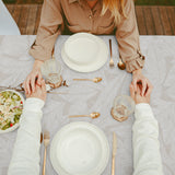 Nordfavn Edna – Akrylduk med diskré bladmønster på sandfarget bunn, bord