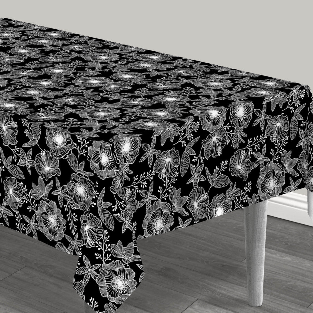 Filligranhagen Hvit – voksduk med strekblomster i hvitt på svart