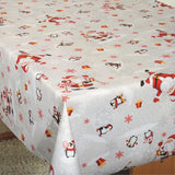 Julefest på Sydpolen juleduk på bord, med morsomme julenisser og pingviner