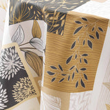 Nærbilde av duk med bladmotiv i beige