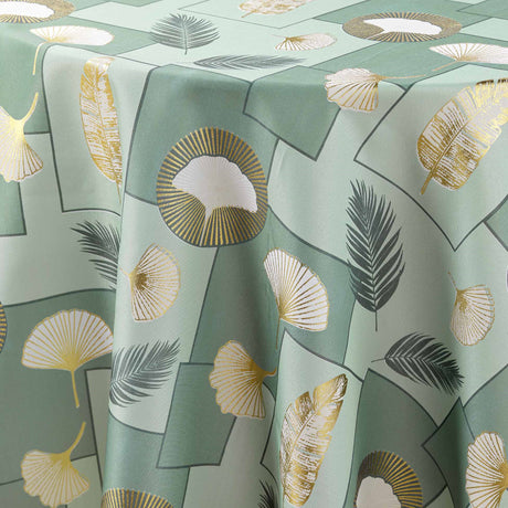 Nærbilde av Natane Sage rund duks bladmønster med gulldetaljer