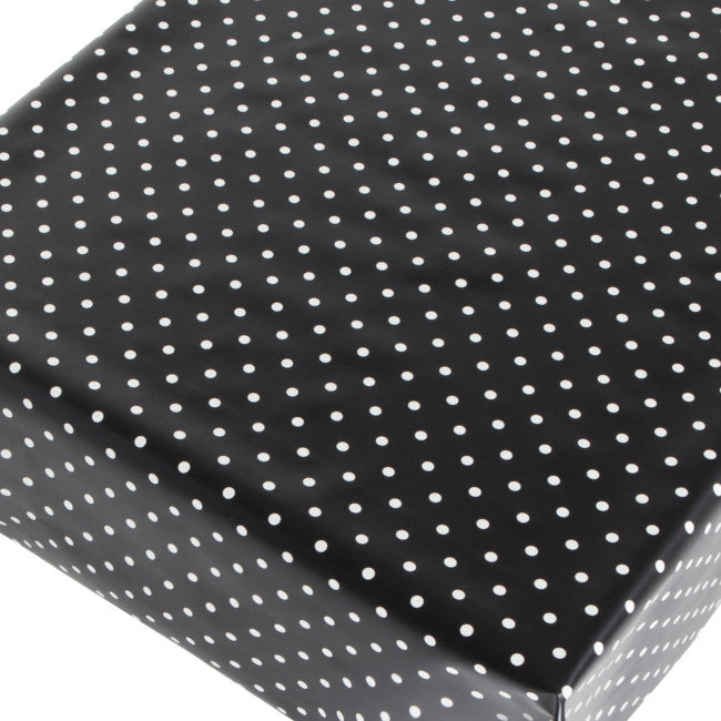 Voksduk med hvite prikker på svart bunn