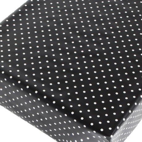 Voksduk med hvite prikker på svart bunn