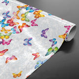 Voksduk med sommerfugler på rad og i mange farger